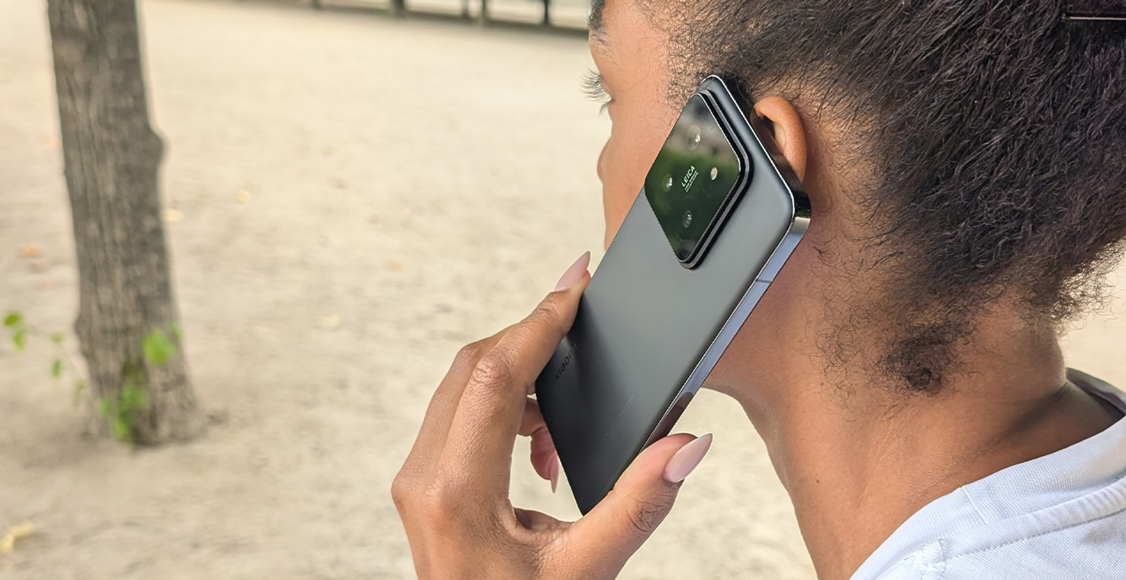 Eine Frau hält sich das Xiaomi 14T zum telefonieren an ihr Ohr